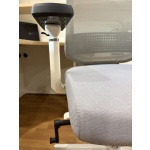Harpo chair close-up side view of an ergonomic office chair featuring a grey mesh backrest, grey fabric seat, white frame, and adjustable armrest in a modern office workspace.