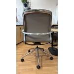 Baye Leather Chair with leather backrest, chrome detailing, and aluminium caster base – rear view.