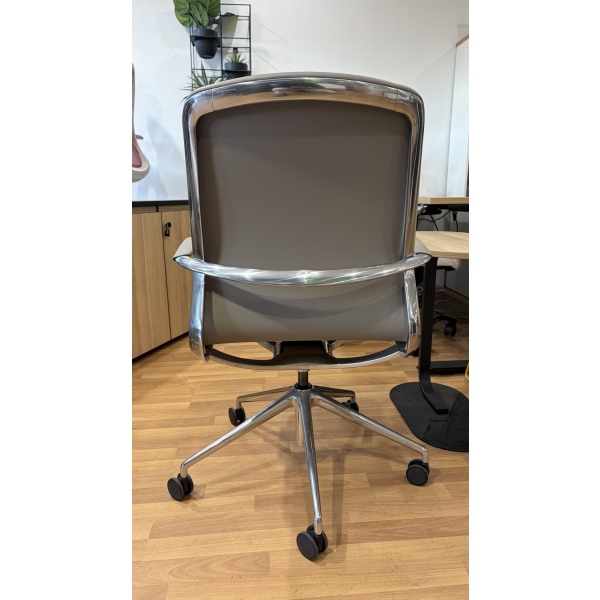 Baye Leather Chair with leather backrest, chrome detailing, and aluminium caster base – rear view.